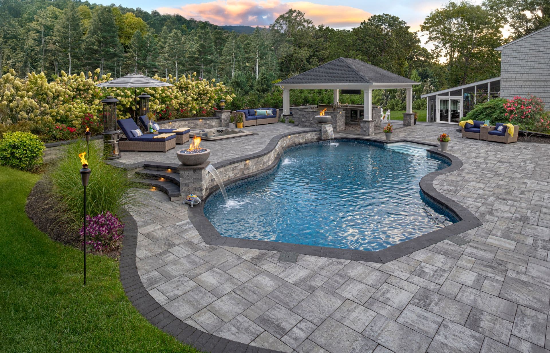Pavers around a pool and outdoor living area.